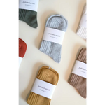 Packaged ribbed socks in earthy tones for soft, flexible everyday wear
