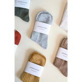 Packaged ribbed socks in earthy tones for soft, flexible everyday wear