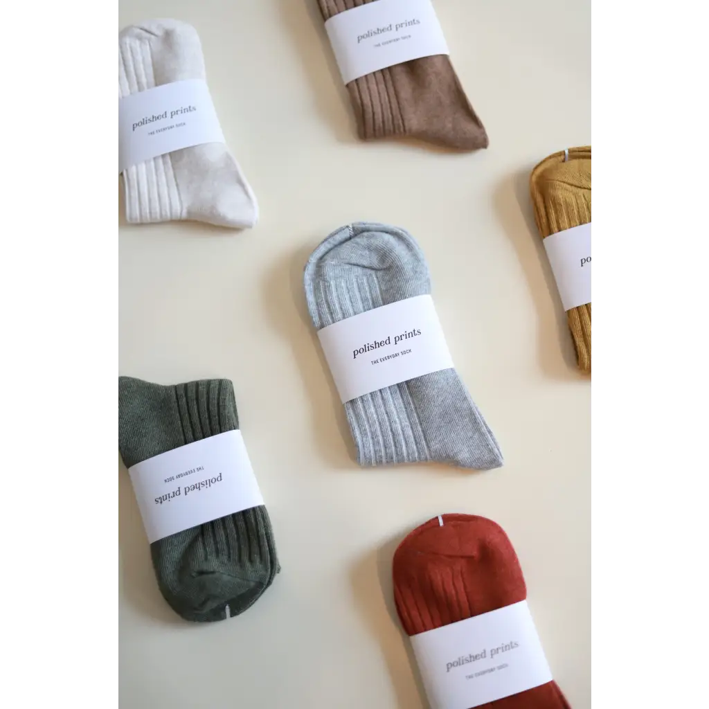 Collection of soft, flexible everyday socks in earthy colors with paper labels