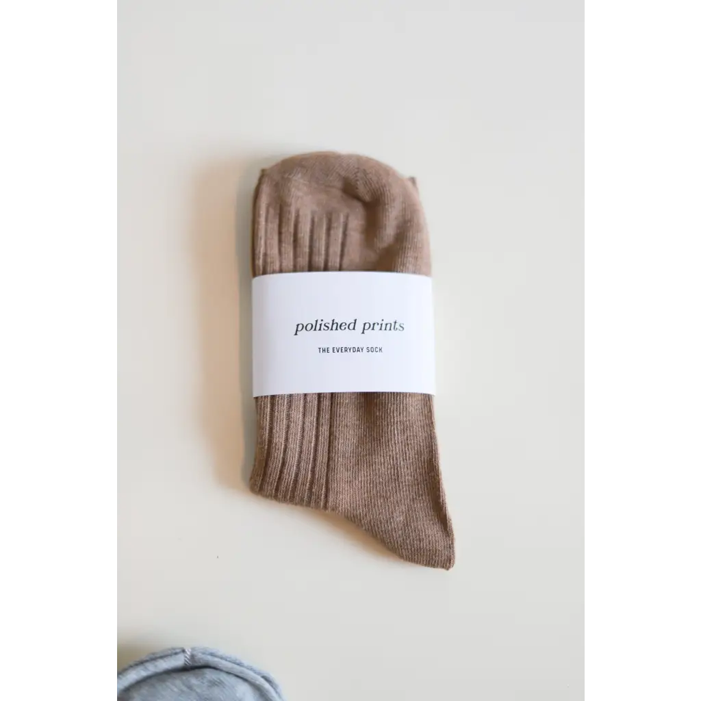 Beige ribbed cotton sock with label, perfect for soft and flexible everyday wear