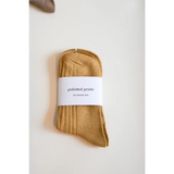 Folded mustard-yellow sock with a label, perfect for soft and flexible everyday wear