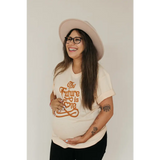 Joyful person rocking a Cream Love Graphic T-shirt with polished prints and a pink hat