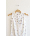 White floral sleeveless dress hanging on a hanger, super soft organic cotton henley romper