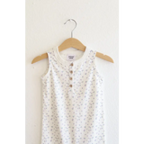 White floral sleeveless dress hanging on a hanger, super soft organic cotton henley romper