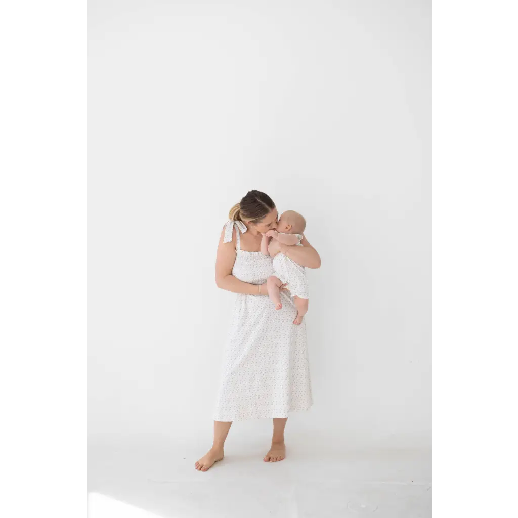 Tender parent-baby moment in super soft organic cotton Henley romper with floral print