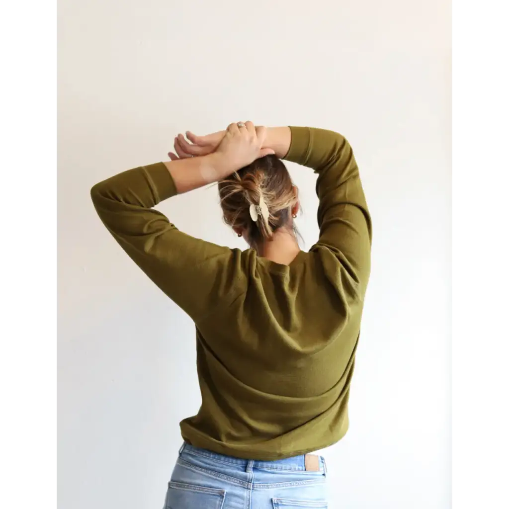 Olive green Jenna Knitted Waffle Longsleeve Pullover with light blue jeans from behind