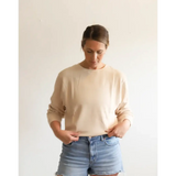 Cream-colored Jenna Knitted Waffle Longsleeve Pullover with light wash denim shorts