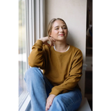 Person in a mustard yellow Jenna Knitted Waffle Longsleeve Pullover and light blue jeans