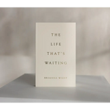 White book titled The Life That’s Waiting by Brianna Wiest with minimalist cover design