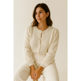 Woman wearing a luxe pointelle Henley sweater with lace-like patterns on the chest