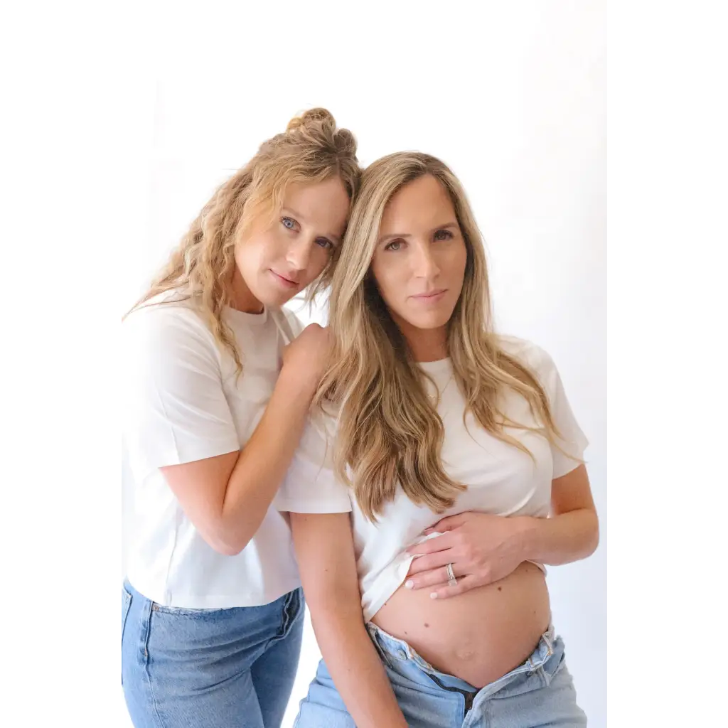 Two women, one pregnant, wearing The Mom Crop boxy tee in Antique White for a stylish mom crop look