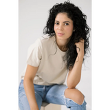 Person in beige Mom Crop Tee in Bone White with ripped jeans for a polished look