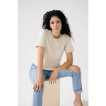 Woman in a cream mom crop tee and distressed jeans for a polished look in bone white