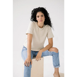 Woman in a cream mom crop tee and distressed jeans for a polished look in bone white