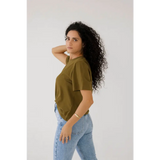 Person in an olive green mom crop boxy tee and light blue jeans for a casual look