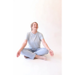 Person sitting cross-legged wearing The Mom Crop in Sky from stylish womens clothes