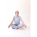 Person sitting cross-legged wearing The Mom Crop in Sky from stylish womens clothes
