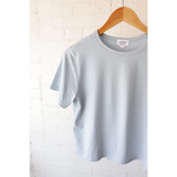 Light blue mom crop T-shirt on wooden hanger from The Mom Crop with polished prints