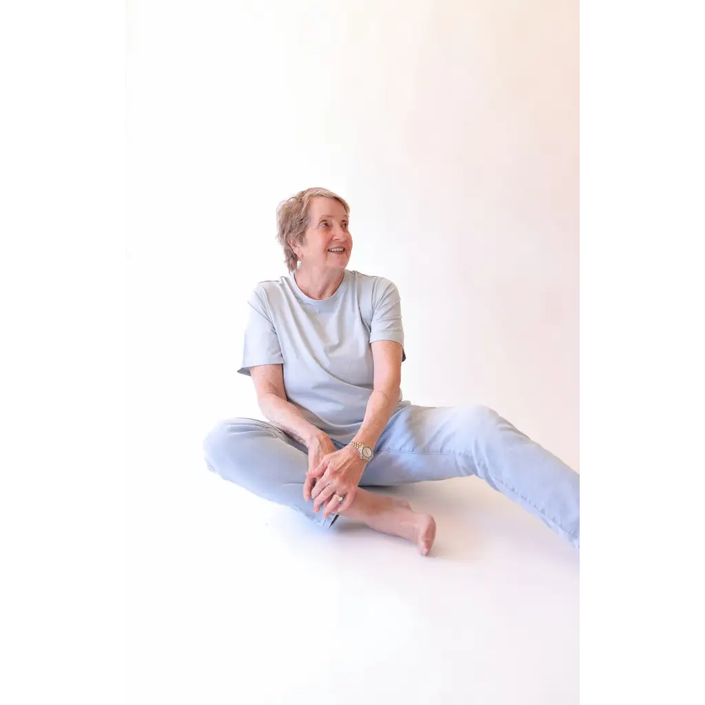 Elderly woman in casual stylish womens clothes wearing The Mom Crop in Sky with polished prints