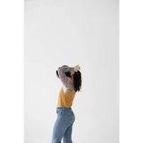 Person in yellow mom tank and blue jeans shows off stylish womens clothes vibe