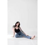 Person in Jet Black Mom Tank with Polished Prints, chilling in blue jeans on the floor