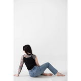 Person in a Jet Black Mom Tank with Polished Prints chilling on the floor in jeans