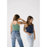 Two people in tank tops and jeans showing off the Navy Transitional Mom Tank with recommended sizing