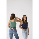 Two tattooed friends rock Navy Transitional Mom Tank Tops with recommend sizing style