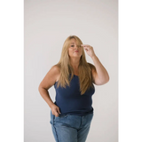 Woman in a navy transitional mom tank top showing recommended sizing, stylish and casual