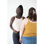 Two friends in casual tank tops showing off the Shifting Sand Mom Tank with Polished Prints