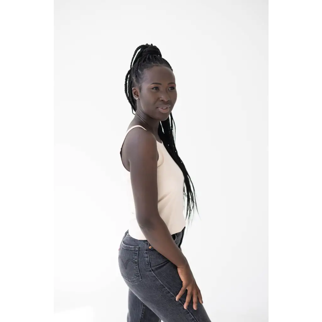 Person in a white mom tank and jeans showcasing the Shifting Sand with Polished Prints
