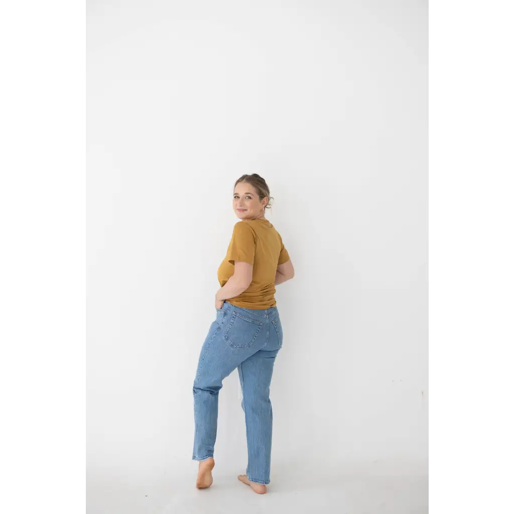 Light blue distressed jeans with straight-leg cut styled with Versatile Mom Tee in Organic Cotton Spandex Blend