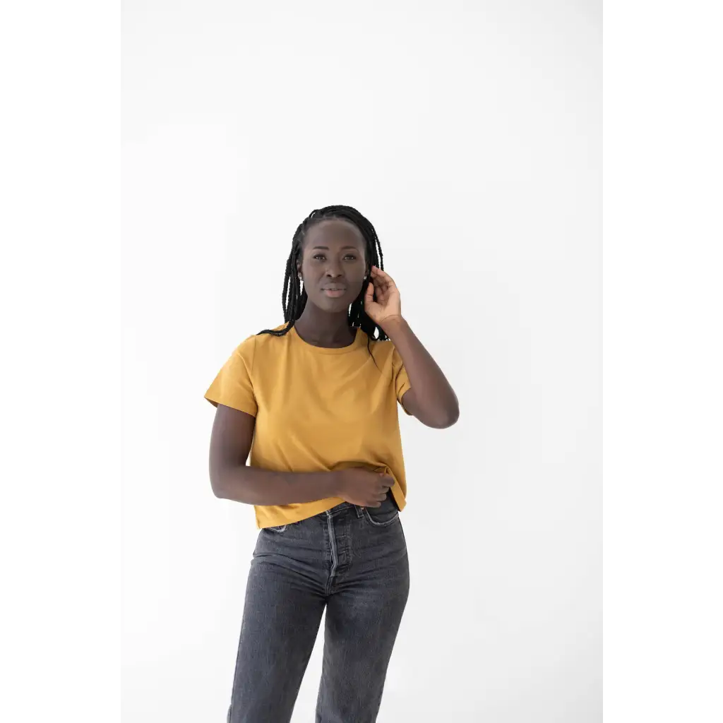 Person in a yellow mom tee made of organic cotton and spandex blend chatting on the phone