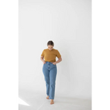 Light blue high-waisted jeans with a mustard yellow mom tee in organic cotton spandex blend
