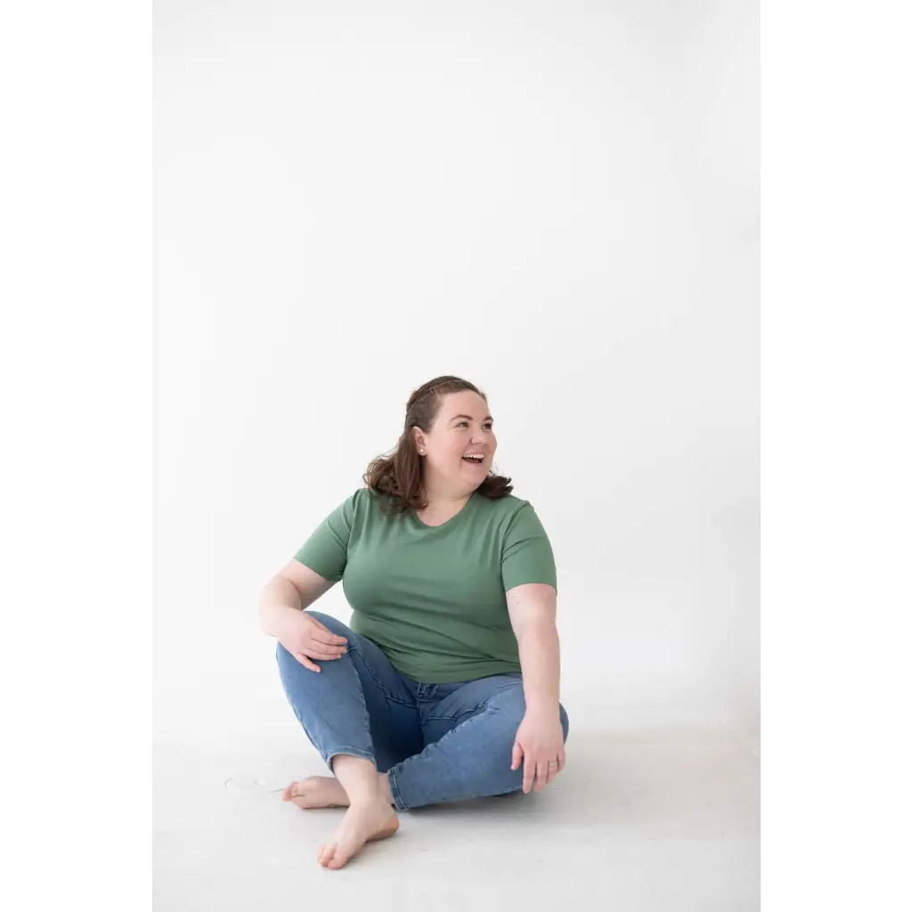 Person in a green mom tee made of organic cotton and spandex blend, comfy vibes