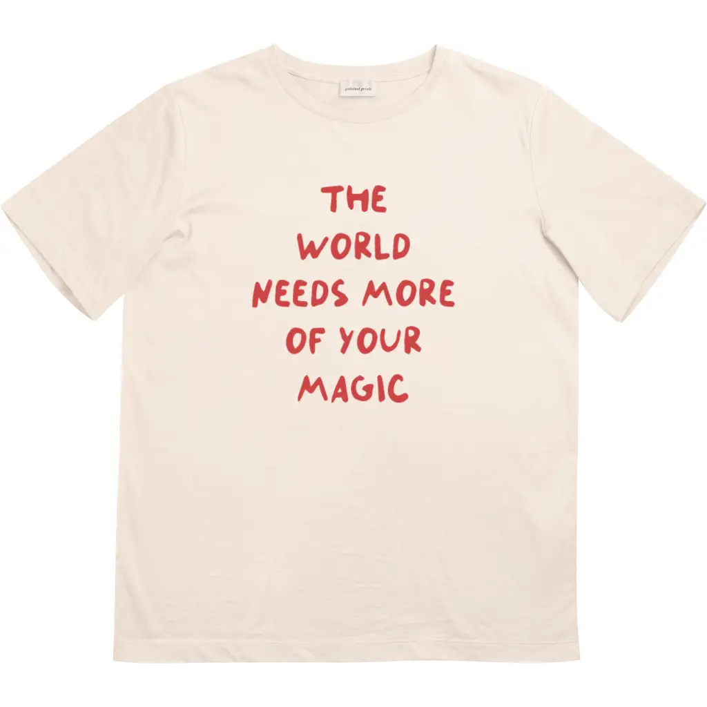 Beige kids t-shirt with bold red lettering from The World Needs More of Your Magic collection