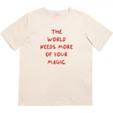 Beige kids t-shirt with bold red lettering from The World Needs More of Your Magic collection