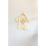 Yellow t-shirt with bold red lettering for kids from The World Needs More of Your Magic