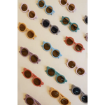 Collection of pastel round retro sunglasses for babies and toddlers arranged stylishly