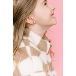 Side profile of girl in turtleneck showcasing Unicorn Stud Earrings for active girls