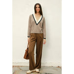 Woman in beige Varsity Contrast Deep V Neck Sweater with polished prints and stylish womens clothes