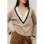 Stylish womens clothes: woman in Varsity Contrast Deep V Neck Sweater with satin pants