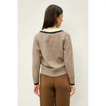 Stylish womens clothes: Woman wearing beige Varsity Contrast Deep V Neck Sweater with black accents