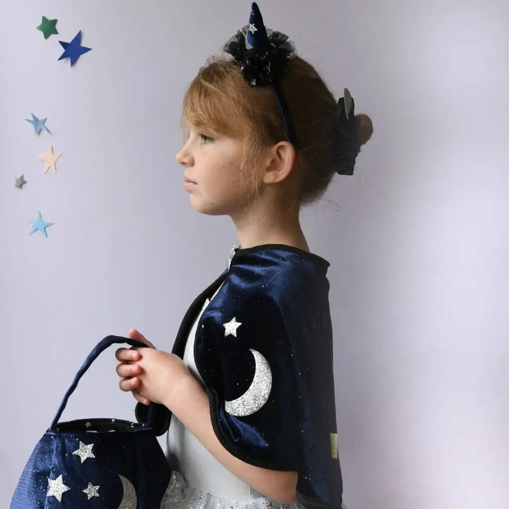 Young girl in Velvet Twilight Cauldron Bag with starry cape and unicorn headband
