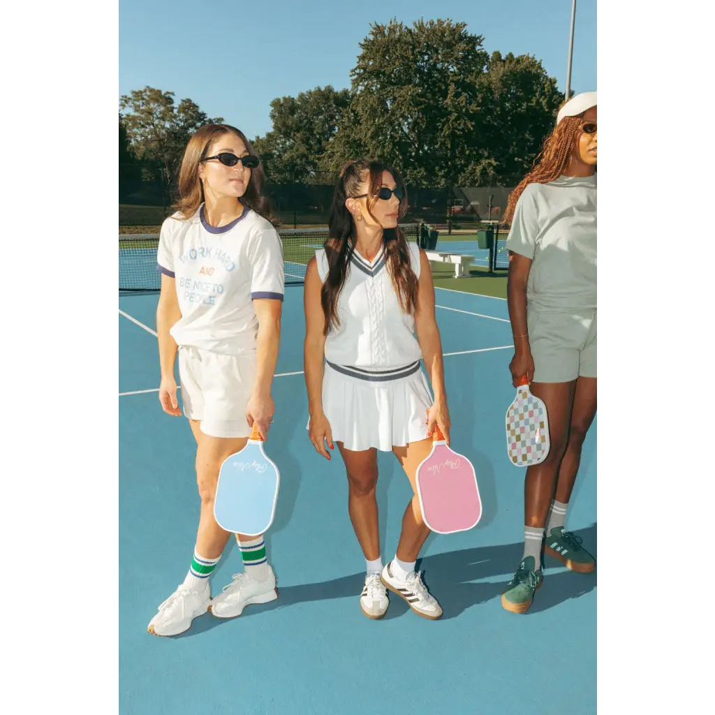 Three friends in Wave Wash Fleece shorts holding pickleball paddles on a sunny court