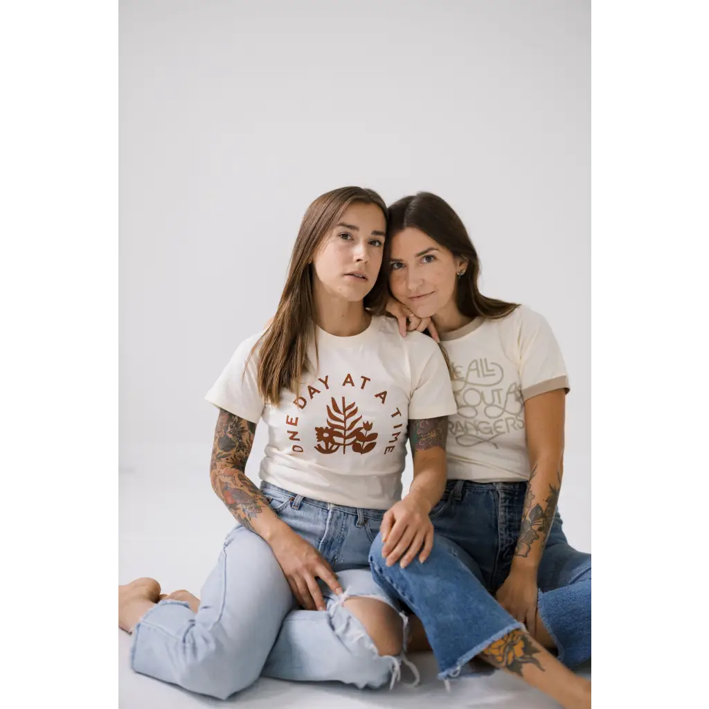 Two friends in ripped jeans and casual tees rocking the Strangers Ringer Tee together