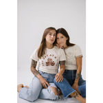 Two friends in ripped jeans and casual tees rocking the Strangers Ringer Tee together