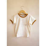 White Everyday Ringer Tee for Kids with Dove Designs hanging on a hanger