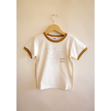 White Everyday Ringer Tee for Kids with Dove Designs hanging on a hanger