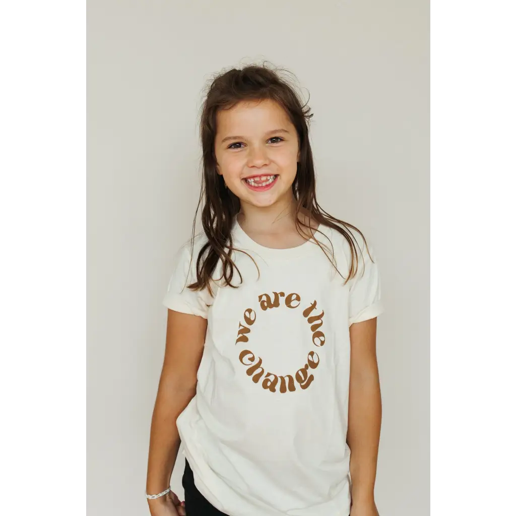 White kids graphic tee in organic cotton featuring a stylish brown circular text design